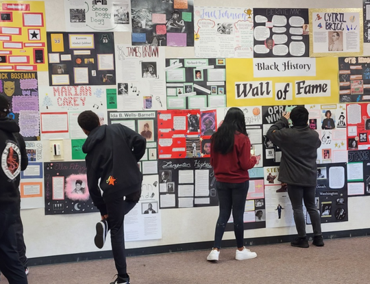Students standing in front of the Black History Wall of Fame