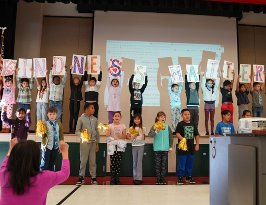 Students holding up the words "Kindness Matters"