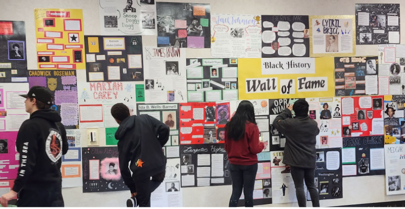 Kids in front of a black history wall